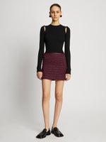 Front full length image of model wearing Faux Leather Smocked Mini Skirt in PLUM