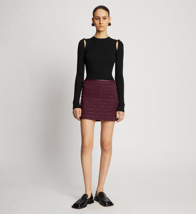 Front full length image of model wearing Faux Leather Smocked Mini Skirt in PLUM