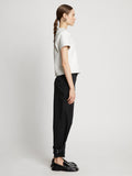 Side full length image of model wearing Cotton Twill Tapered Pants in BLACK