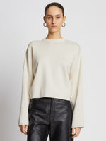 Front cropped image of model wearing Twist Long Sleeve Sweater in CREAM