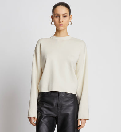 Front cropped image of model wearing Twist Long Sleeve Sweater in CREAM