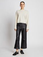 Front full length image of model wearing Twist Long Sleeve Sweater in CREAM