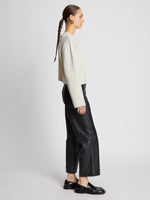Side full length image of model wearing Twist Long Sleeve Sweater in CREAM