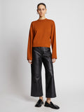 Front full length image of model wearing Twist Long Sleeve Sweater in HONEY