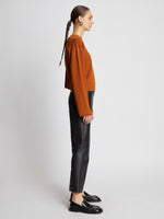Side full length image of model wearing Twist Long Sleeve Sweater in HONEY