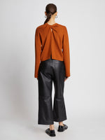 Back full length image of model wearing Twist Long Sleeve Sweater in HONEY