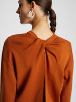Detail image of model wearing Twist Long Sleeve Sweater in HONEY