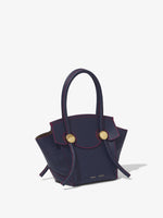 Side image of Small Grainy Leather Pipe Bag in navy/red