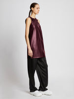 Side full length image of model wearing Faux Leather Sleeveless Dress in PLUM