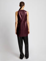 Back full length image of model wearing Faux Leather Sleeveless Dress in PLUM