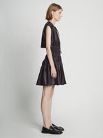 Side full length image of model wearing Faux Leather Drawstring Dress in BLACK