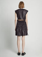Back full length image of model wearing Faux Leather Drawstring Dress in BLACK