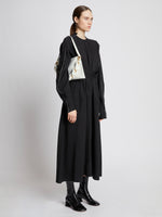 Image of model carrying Braid Bag in OPTIC WHITE on shoulder