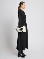 Image of model carrying Braid Bag in OPTIC WHITE in hand
