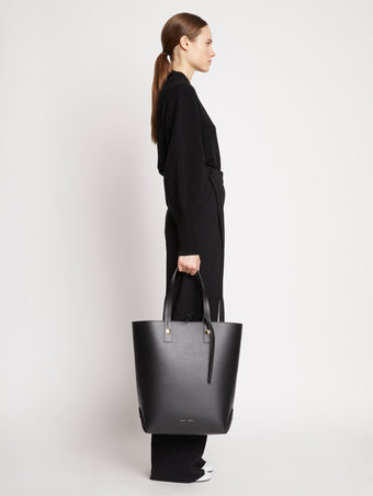 Image of model carrying North South Tobo Tote in black