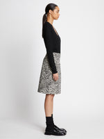 Side full length image of model wearing Eco Superfine Merino Scoop Neck Sweater in BLACK