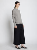 Side full length image of model wearing Eco Superfine Merino Sweater in GREY MELANGE