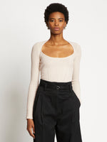 Front cropped image of model wearing Plaited Rib Scoop Neck Sweater in BONE/PALE CASHEW