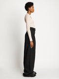 Side full length image of model wearing Plaited Rib Scoop Neck Sweater in BONE/PALE CASHEW