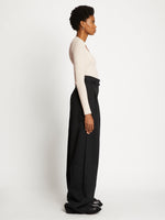Side full length image of model wearing Plaited Rib Scoop Neck Sweater in BONE/PALE CASHEW