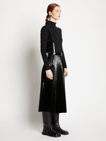 Image of model carrying Small Accordion Flap Bag in BLACK on shoulder