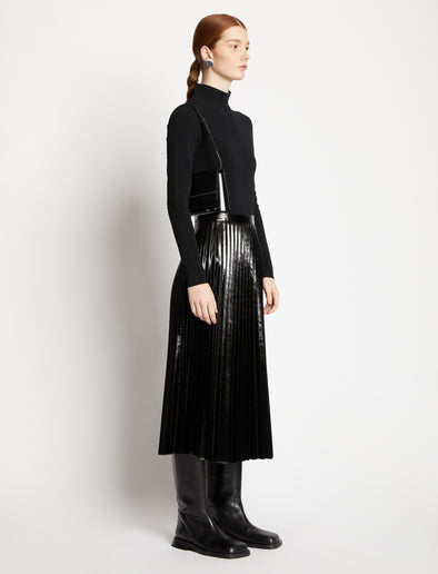 Image of model carrying Small Accordion Flap Bag in BLACK on shoulder