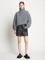 Front full length image of model wearing Faux Leather Mini Skirt in BLACK