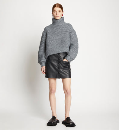 Front full length image of model wearing Faux Leather Mini Skirt in BLACK