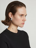 Proenza Schouler Image of model wearing mini hoop earrings in optic white