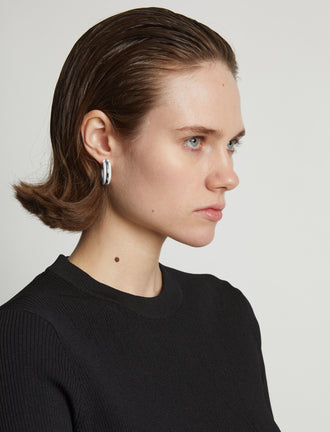 Proenza Schouler Image of model wearing mini hoop earrings in optic white