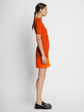 Side full length image of model wearing Compact Viscose Knit Top in TANGERINE