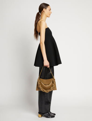 Front image of model carrying Braid Bag in TRUFFLE