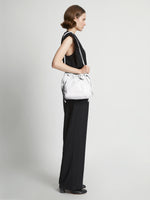 Image of model carrying Drawstring Pouch in OPTIC WHITE