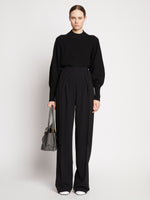 Image of model wearing Small Grainy Leather Pipe Bag in STONE
