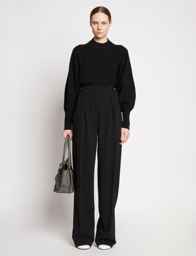 Image of model wearing Small Grainy Leather Pipe Bag in STONE