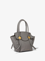 Side image of Small Grainy Leather Pipe Bag in STONE