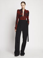 Front full length image of model wearing Painted Spiral Crepe De Chine V-Neck Top in RED MULTI