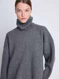 Detail image of model wearing Doubleface Eco Cashmere Oversized Turtleneck Sweater in GREY MELANGE