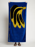Image of model holding Banana Beach Towel in ROYAL BLUE/YELLOW/BLACK