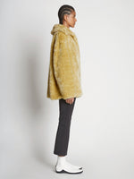 Side full length image of model wearing Faux Rabbit Peacoat in SAND