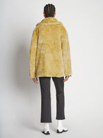 Back full length image of model wearing Faux Rabbit Peacoat in SAND