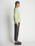 Side full length image of model wearing Long Sleeve Sweatshirt in GREEN TEA