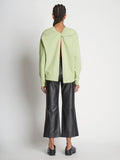Back full length image of model wearing Long Sleeve Sweatshirt in GREEN TEA