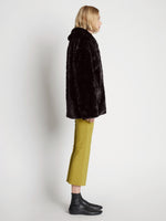 Side full length image of model wearing Faux Rabbit Peacoat in BLACK