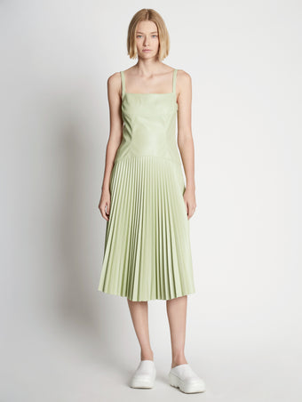Front full length image of model wearing Drop Waist Faux Leather Dress
 in GREEN TEA