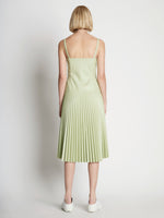 Back full length image of model wearing Drop Waist Faux Leather Dress
 in GREEN TEA
