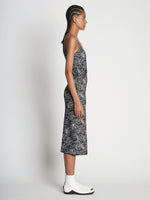 Side full length image of model wearing Speckle Knit Dress in PEARL/BLACK