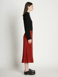 Side full length image of model wearing Pleatable Crepe Midi Skirt
 in VERMILLION/BLACK
