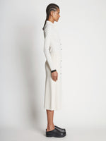 Side full length image of model wearing Rib Knit Button Front Skirt in CREAM