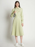 Front full length image of model wearing Faux Leather Pleated Skirt in GREEN TEA